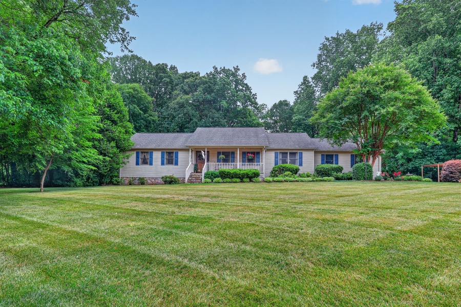 A North Carolina home with a wide green lawn at golden hour